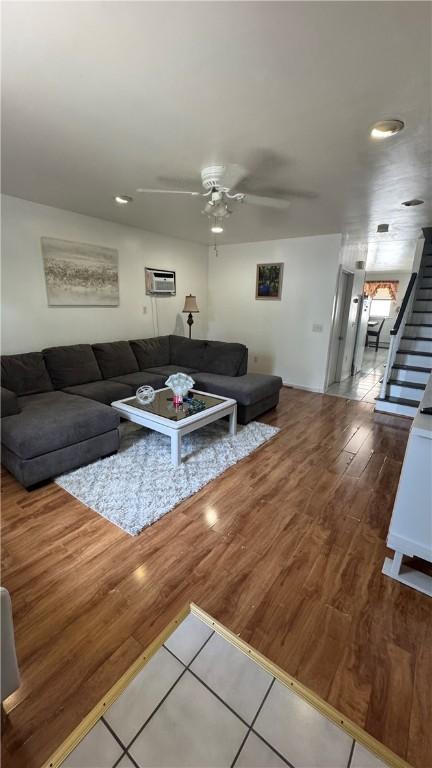 179 Wallace St, Providence, RI 02909 - living area with ceiling fan, stairs, wood finished floors, a wall unit AC, and recessed lighting