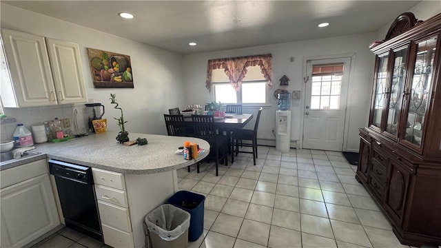 179 Wallace St, Providence, RI 02909 - kitchen with black dishwasher, a peninsula, light countertops, white cabinetry, and light tile patterned floors