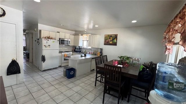 179 Wallace St, Providence, RI 02909 - kitchen with white appliances, a peninsula, light tile patterned flooring, recessed lighting, and backsplash