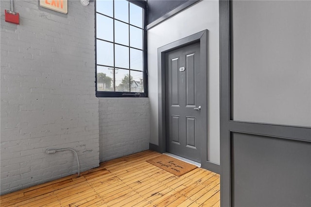 685 Social St Unit 114, Woonsocket, RI 02895 - doorway with brick wall and hardwood / wood-style flooring