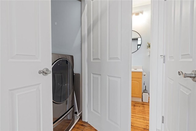 685 Social St Unit 114, Woonsocket, RI 02895 - laundry area featuring washer / dryer and light wood-type flooring