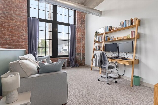 685 Social St Unit 114, Woonsocket, RI 02895 - office area featuring carpet, plenty of natural light, brick wall, and a towering ceiling