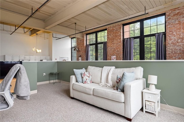 685 Social St Unit 114, Woonsocket, RI 02895 - living room with brick wall, carpet, beam ceiling, and a towering ceiling