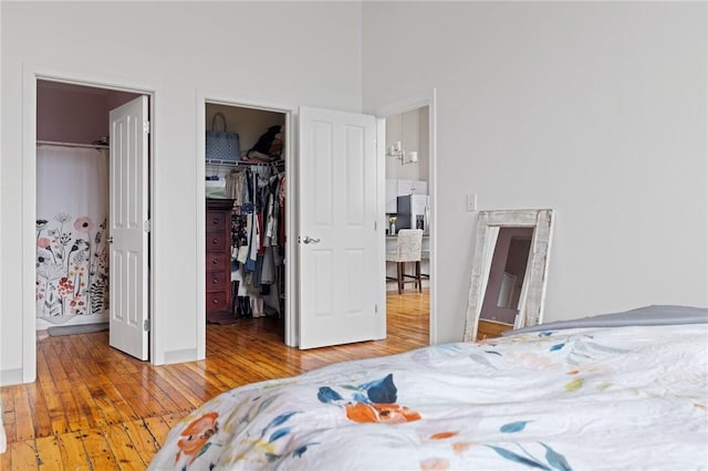 685 Social St Unit 114, Woonsocket, RI 02895 - bedroom with hardwood / wood-style flooring, a spacious closet, stainless steel refrigerator with ice dispenser, and a closet