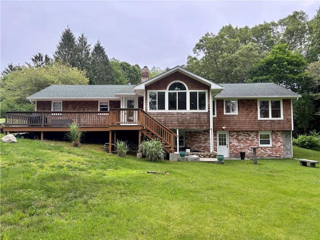 10 Lakeside Dr, Charlestown, RI 02813 - rear view of property featuring a chimney, a wooden deck, a yard, and roof with shingles