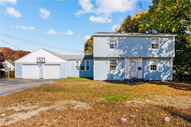 211 Tiogue Ave, Coventry, RI 02816 - colonial-style house featuring a front yard, entry steps, and a detached garage