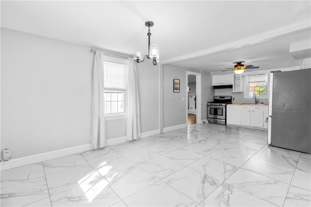 211 Tiogue Ave, Coventry, RI 02816 - dining area featuring light marble finish flooring, a chandelier, and a ceiling fan
