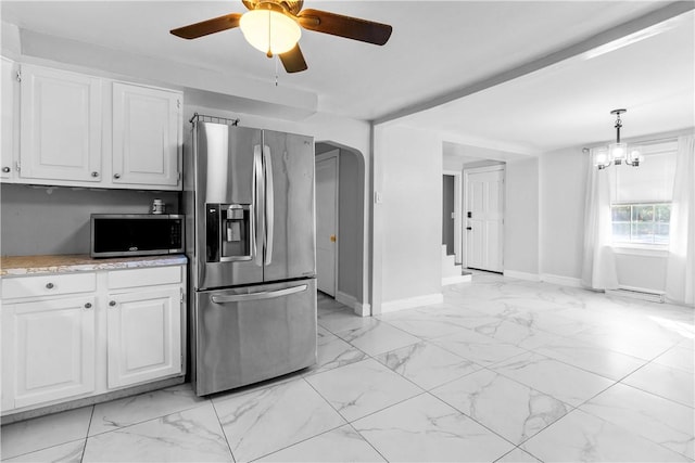 211 Tiogue Ave, Coventry, RI 02816 - kitchen featuring stainless steel appliances, light marble finish flooring, white cabinetry, and a ceiling fan
