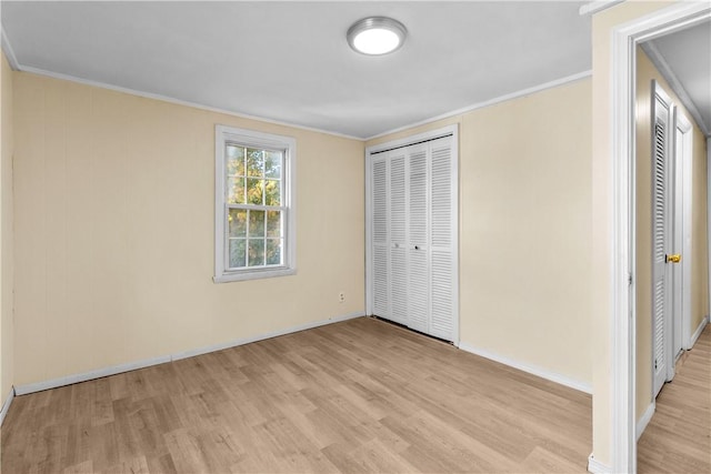 211 Tiogue Ave, Coventry, RI 02816 - unfurnished bedroom with light wood-style flooring, ornamental molding, and a closet