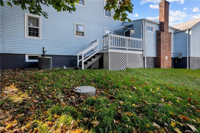 211 Tiogue Ave, Coventry, RI 02816 - back of property with a deck, a yard, and stairs