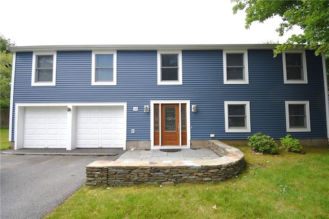 92 Trout Dr, Middletown, RI 02842 - view of front of house with a garage, asphalt driveway, and a front lawn