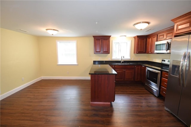 92 Trout Dr, Middletown, RI 02842 - kitchen featuring appliances with stainless steel finishes, dark countertops, and dark wood-type flooring