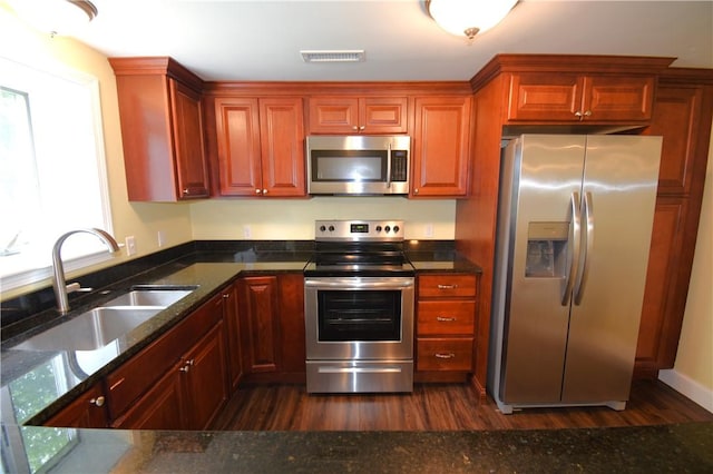 92 Trout Dr, Middletown, RI 02842 - kitchen featuring stainless steel appliances, dark wood finished floors, and dark stone counters
