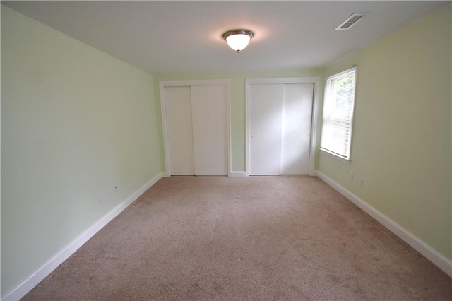 92 Trout Dr, Middletown, RI 02842 - unfurnished bedroom with two closets and light carpet