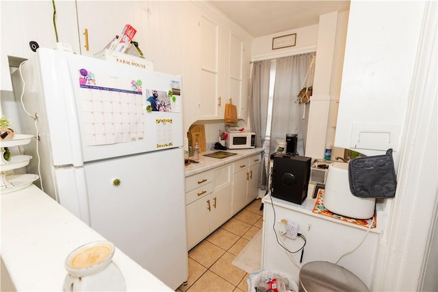 467 Plainfield St, Providence, RI 02909 - kitchen featuring white appliances, light countertops, light tile patterned floors, and white cabinets