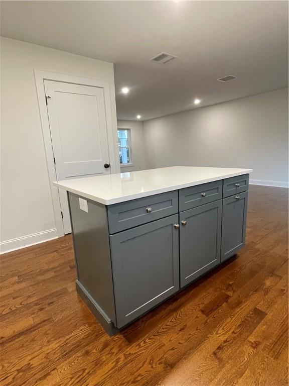 59 Recess Ln, Warwick, RI 02889 - kitchen with gray cabinets, dark wood-style floors, a kitchen island, light countertops, and recessed lighting