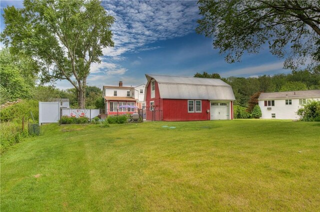 426 Buxton St, North Smithfield, RI 02896 - back of property with a gambrel roof, an outbuilding, a chimney, and a detached garage