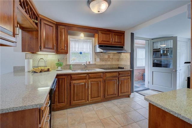 426 Buxton St, North Smithfield, RI 02896 - kitchen with under cabinet range hood, brown cabinetry, decorative backsplash, light tile patterned floors, and black appliances