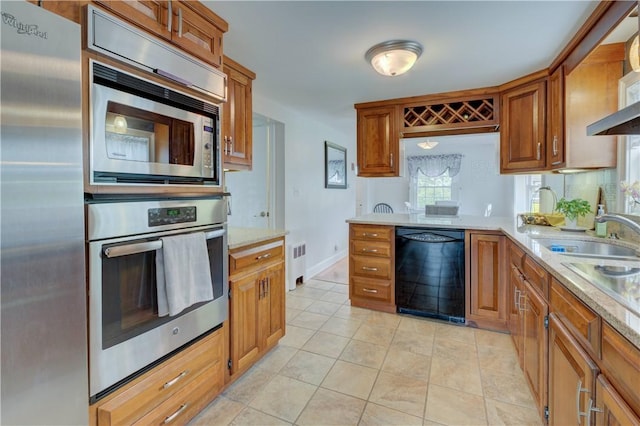 426 Buxton St, North Smithfield, RI 02896 - kitchen with appliances with stainless steel finishes, radiator heating unit, and brown cabinetry