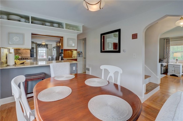 426 Buxton St, North Smithfield, RI 02896 - dining room featuring arched walkways and light wood-type flooring