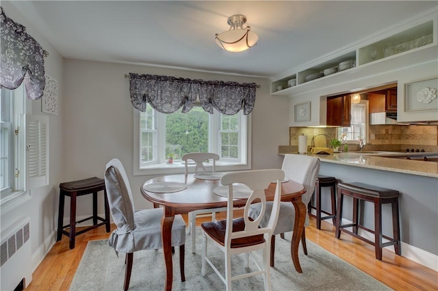 426 Buxton St, North Smithfield, RI 02896 - dining area featuring radiator and light wood-style floors