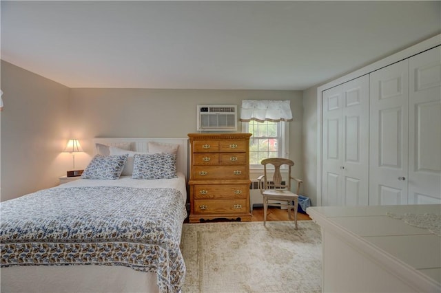 426 Buxton St, North Smithfield, RI 02896 - bedroom featuring a wall unit AC, a closet, and wood finished floors
