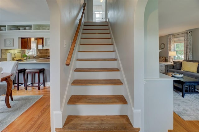 426 Buxton St, North Smithfield, RI 02896 - staircase featuring wood finished floors and arched walkways