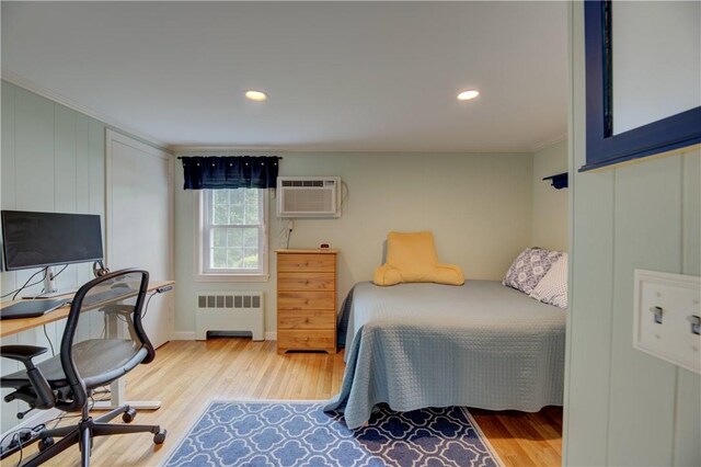 426 Buxton St, North Smithfield, RI 02896 - bedroom with radiator heating unit, crown molding, light wood-style flooring, an AC wall unit, and an office area