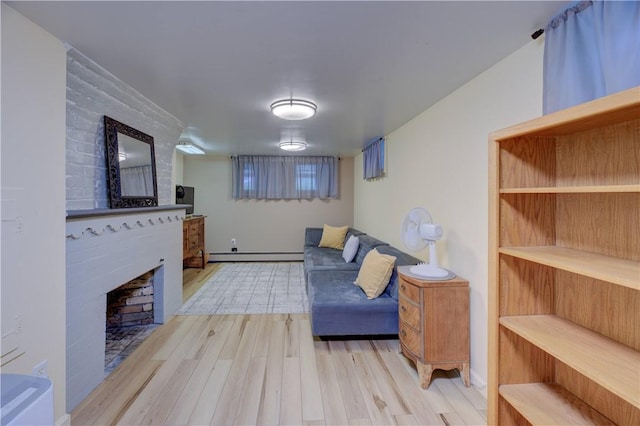 426 Buxton St, North Smithfield, RI 02896 - living area featuring a large fireplace, a baseboard heating unit, and wood finished floors