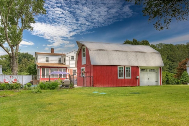 426 Buxton St, North Smithfield, RI 02896 - rear view of property featuring a gambrel roof, a sunroom, a garage, a chimney, and an outdoor structure