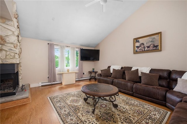2970 Mendon Rd Unit 154, Cumberland, RI 02864 - living room featuring lofted ceiling, a baseboard radiator, ceiling fan, a stone fireplace, and wood finished floors