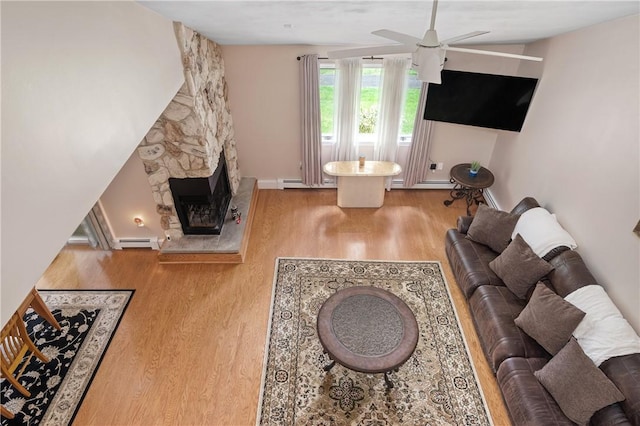 2970 Mendon Rd Unit 154, Cumberland, RI 02864 - living area with wood finished floors, ceiling fan, baseboard heating, and a stone fireplace