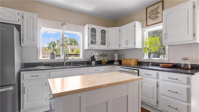 280 Woodbine St, Cranston, RI 02910 - kitchen with appliances with stainless steel finishes, butcher block countertops, white cabinets, and decorative backsplash