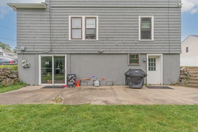 12 Lenox St, Cumberland, RI 02864 - back of house with a patio and a lawn