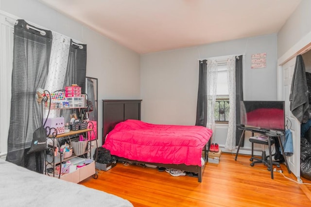 12 Lenox St, Cumberland, RI 02864 - bedroom featuring wood finished floors and a baseboard radiator
