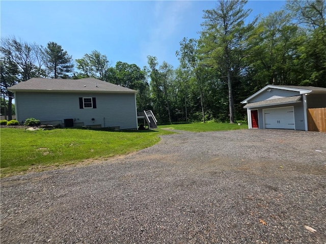 475 Danielson Pike, Scituate, RI 02857 - view of property exterior with a detached garage, an outdoor structure, a lawn, and driveway