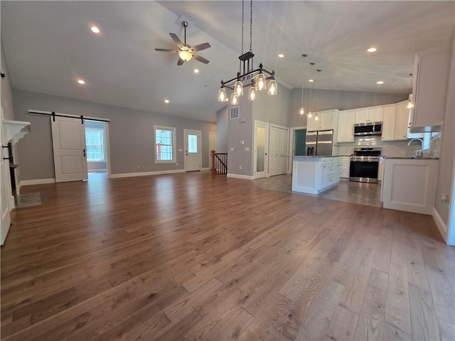 475 Danielson Pike, Scituate, RI 02857 - unfurnished living room with a barn door, a ceiling fan, high vaulted ceiling, dark wood-style floors, and recessed lighting