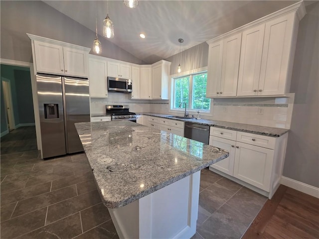 475 Danielson Pike, Scituate, RI 02857 - kitchen featuring stainless steel appliances, vaulted ceiling, white cabinets, a kitchen island, and light stone counters