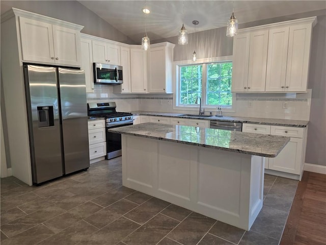 475 Danielson Pike, Scituate, RI 02857 - kitchen with stainless steel appliances, white cabinets, a kitchen island, decorative backsplash, and lofted ceiling