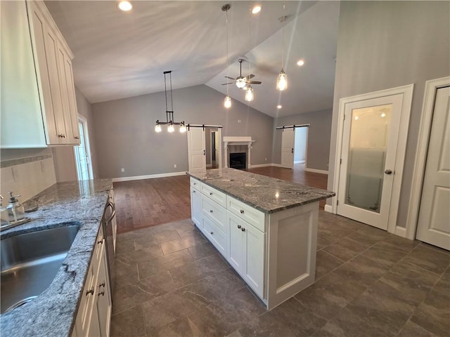 475 Danielson Pike, Scituate, RI 02857 - kitchen with a barn door, open floor plan, lofted ceiling, a ceiling fan, and white cabinets