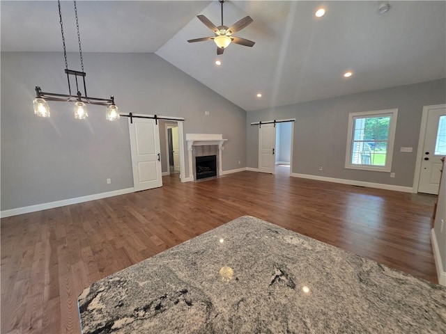 475 Danielson Pike, Scituate, RI 02857 - unfurnished living room featuring a barn door, ceiling fan, wood finished floors, high vaulted ceiling, and recessed lighting