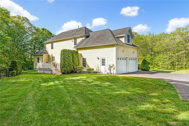 3 Piezzo Dr, Westerly, RI 02891 - view of property exterior featuring asphalt driveway, a yard, a wooden deck, and an attached garage