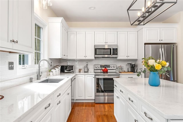 3 Piezzo Dr, Westerly, RI 02891 - kitchen featuring appliances with stainless steel finishes, white cabinetry, tasteful backsplash, and light stone counters