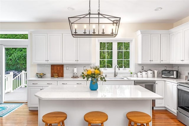 3 Piezzo Dr, Westerly, RI 02891 - kitchen featuring a kitchen breakfast bar, appliances with stainless steel finishes, and white cabinetry