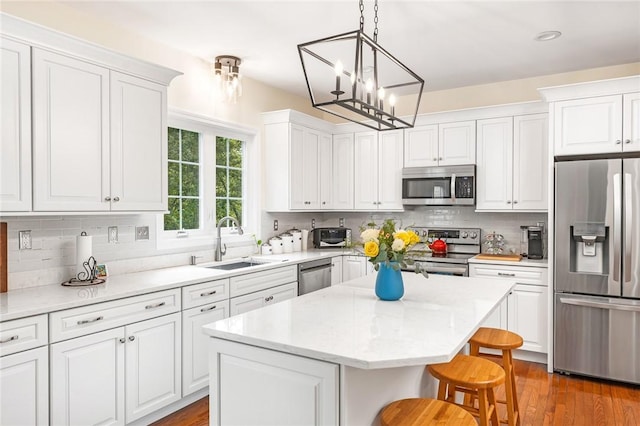 3 Piezzo Dr, Westerly, RI 02891 - kitchen with appliances with stainless steel finishes, white cabinetry, and a center island