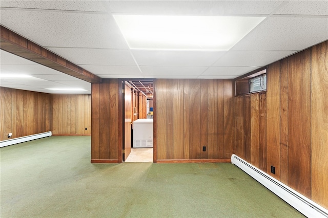 15 Rutland St, Warwick, RI 02888 - finished basement with a baseboard radiator, carpet, a paneled ceiling, and wooden walls