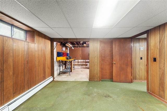 15 Rutland St, Warwick, RI 02888 - basement with a baseboard radiator, wooden walls, carpet, and a paneled ceiling