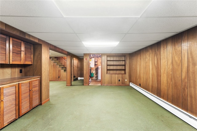 15 Rutland St, Warwick, RI 02888 - finished below grade area with a baseboard heating unit, stairs, carpet, wood walls, and a drop ceiling