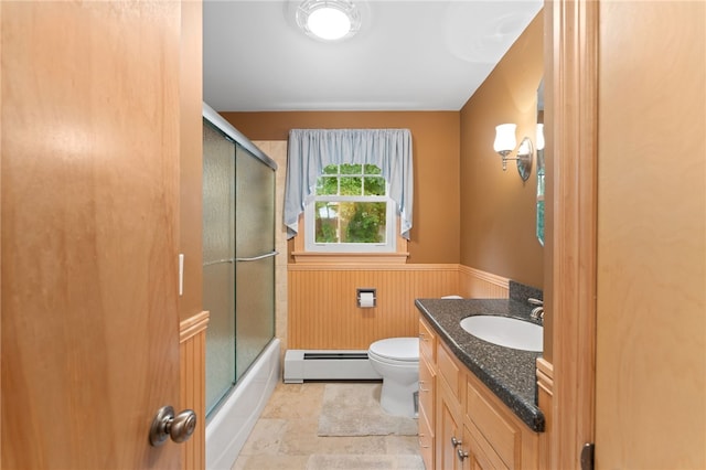 15 Rutland St, Warwick, RI 02888 - bathroom with a baseboard heating unit, wainscoting, vanity, and combined bath / shower with glass door