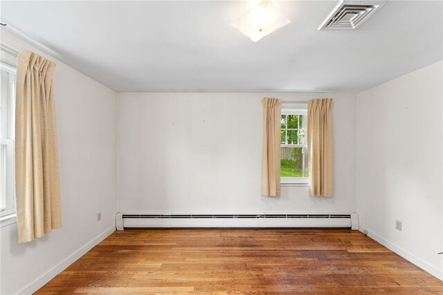 15 Rutland St, Warwick, RI 02888 - empty room with a baseboard radiator and wood finished floors
